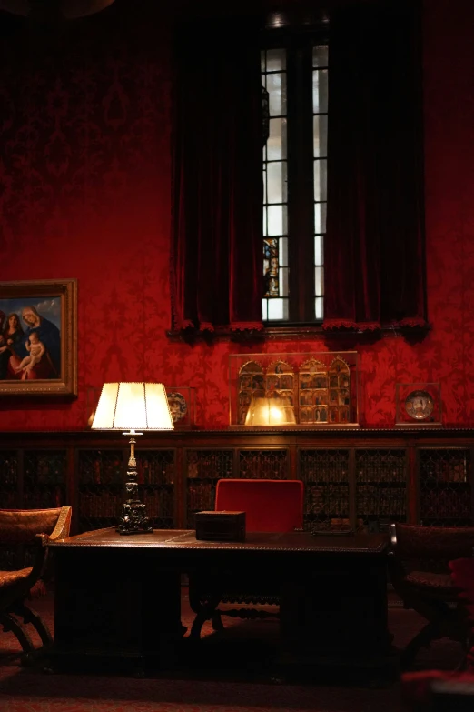 a living room with red walls and a brown table