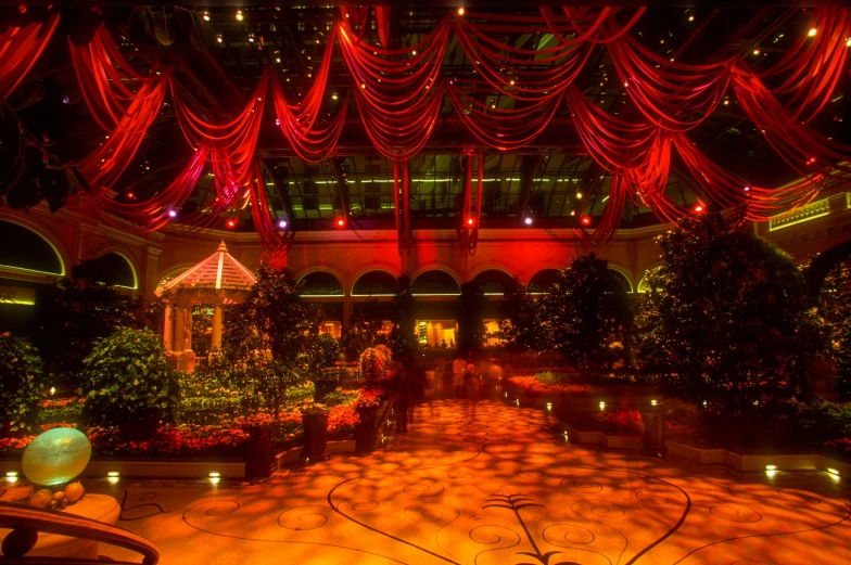 an intricate garden with candles lite up on the ceiling