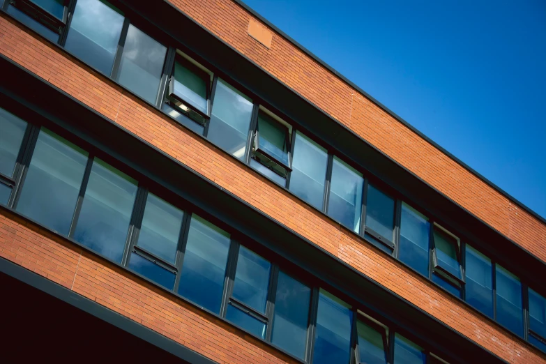 two planes flying over a large brick building