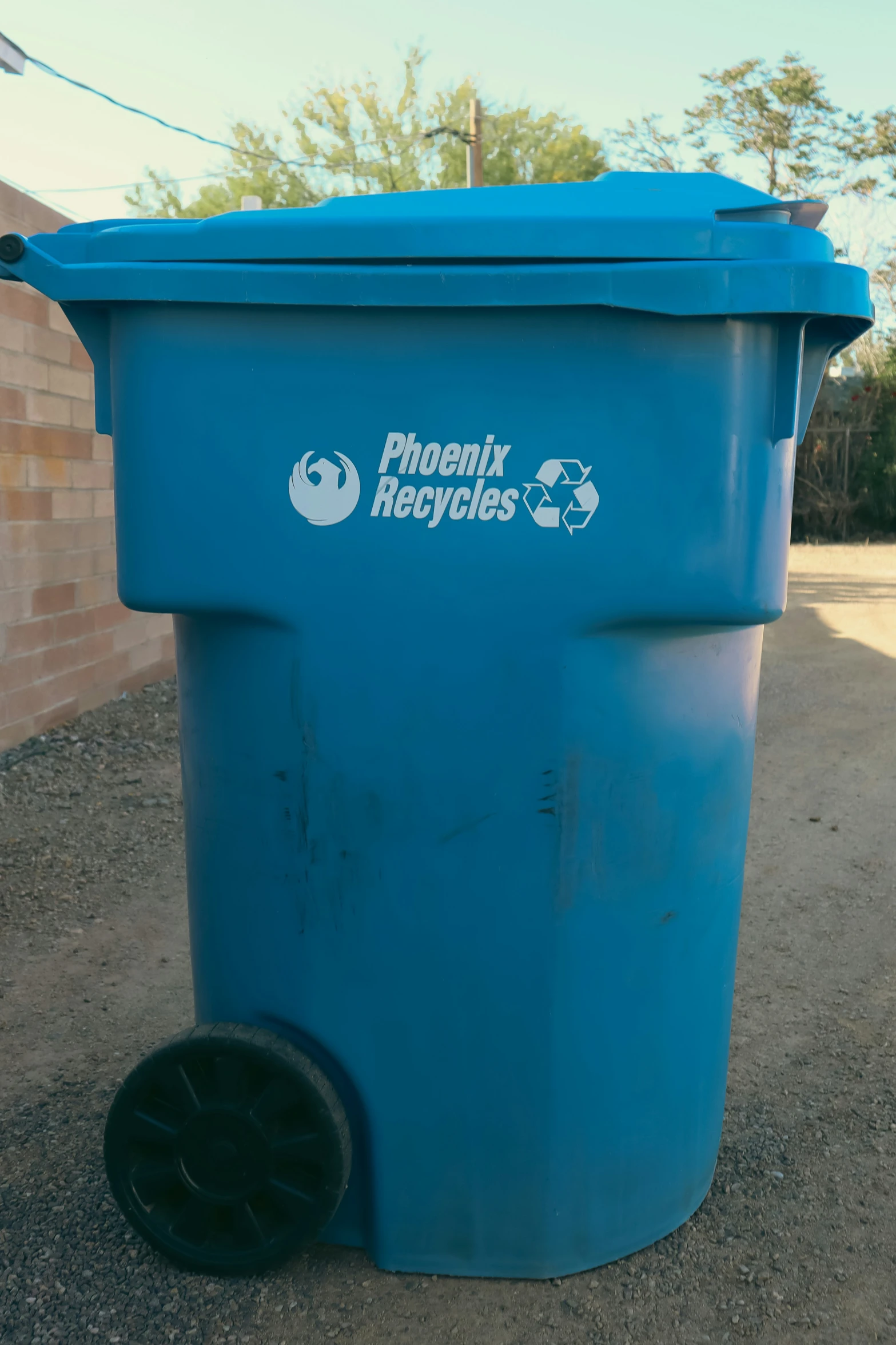 a large blue trash can that has wheels on it