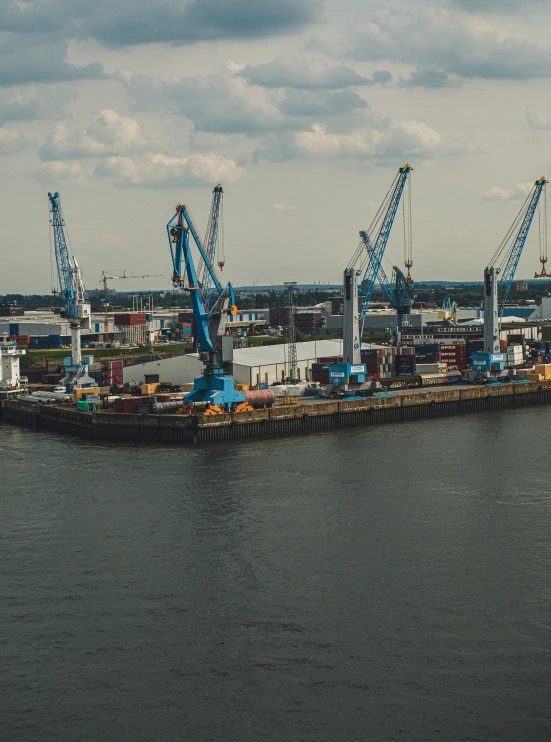 some cranes on a barge in the water