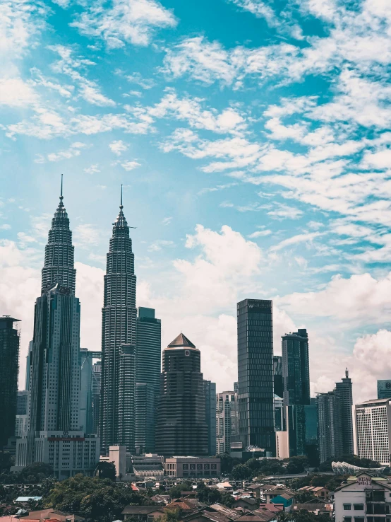 a view of two tall buildings towering over a city