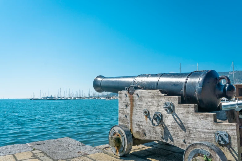 there is a large cannon that is standing on a dock