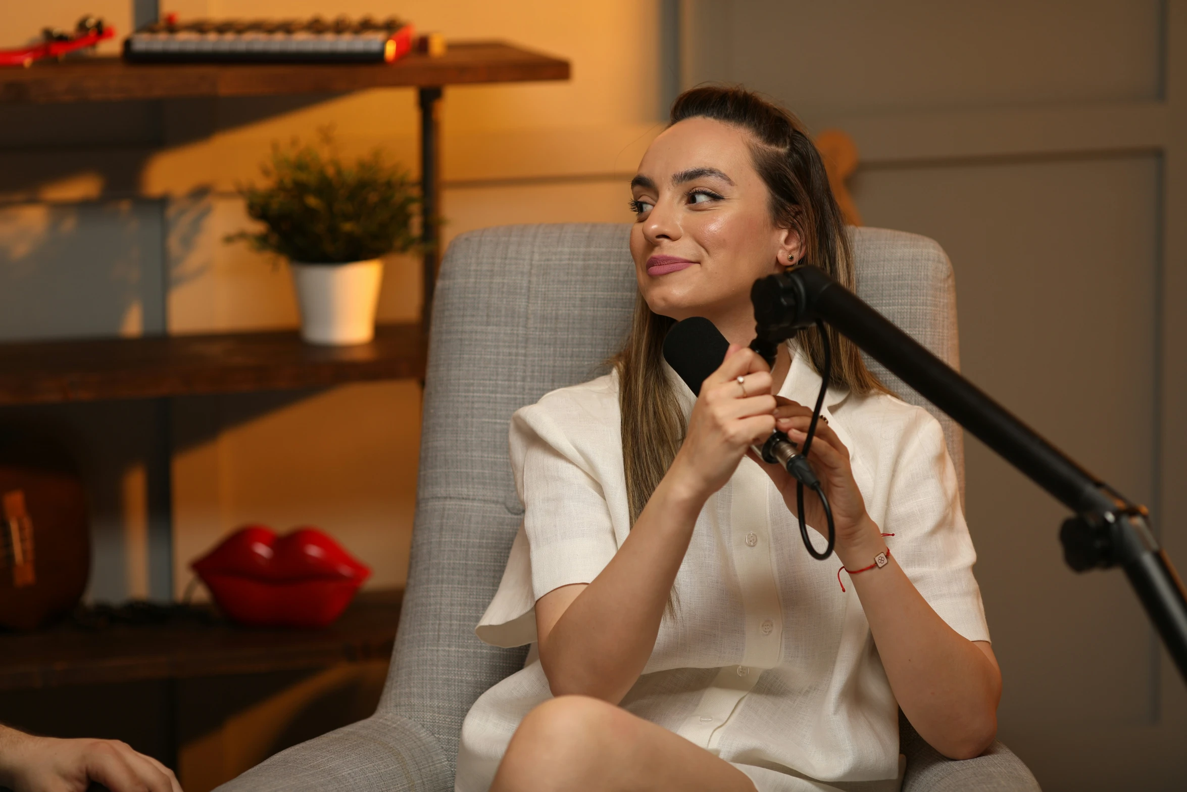 the woman is talking into a microphone on a chair