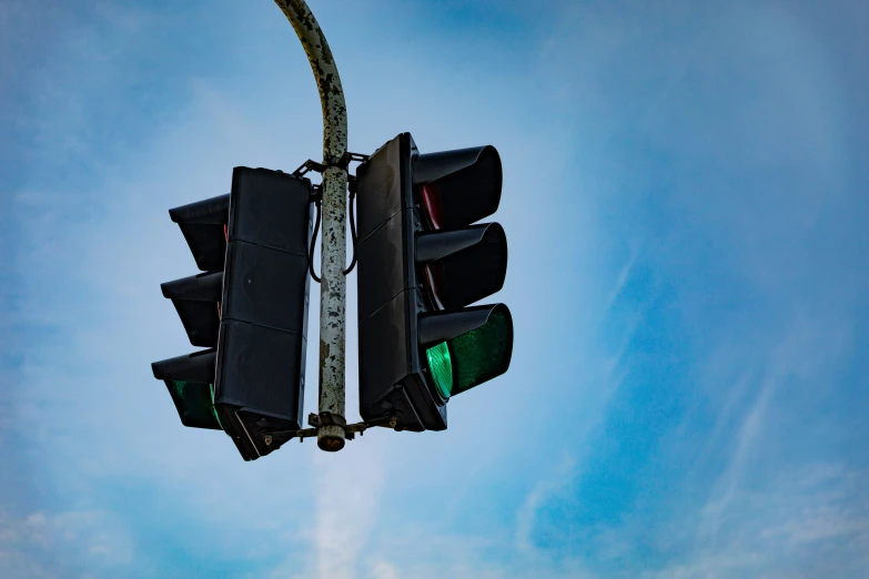 a stop light hanging off the side of a pole