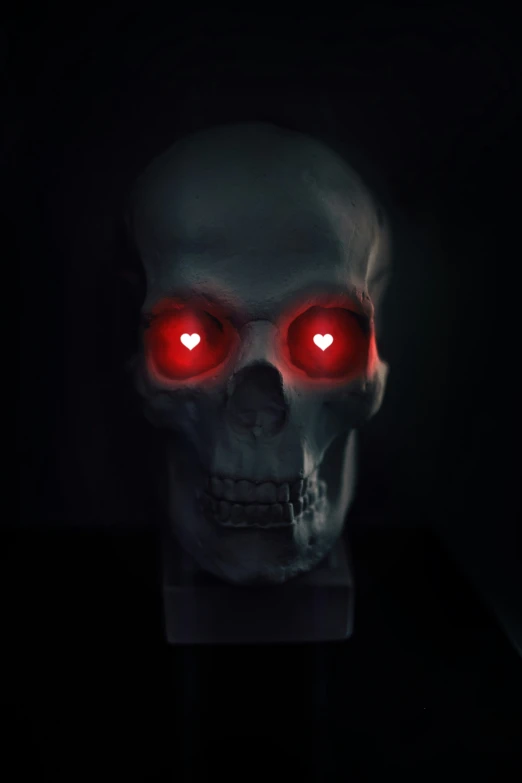 a scary skull wearing bright red eyes in a dark background