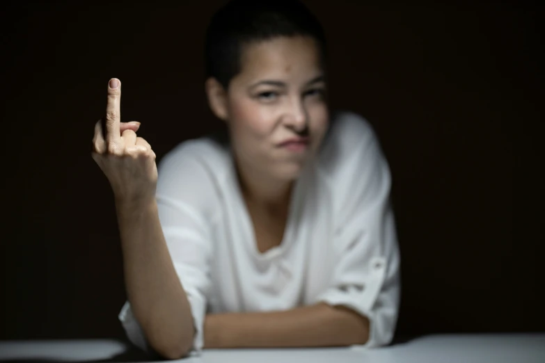 a woman making a hand gesture that is shaped like an animal