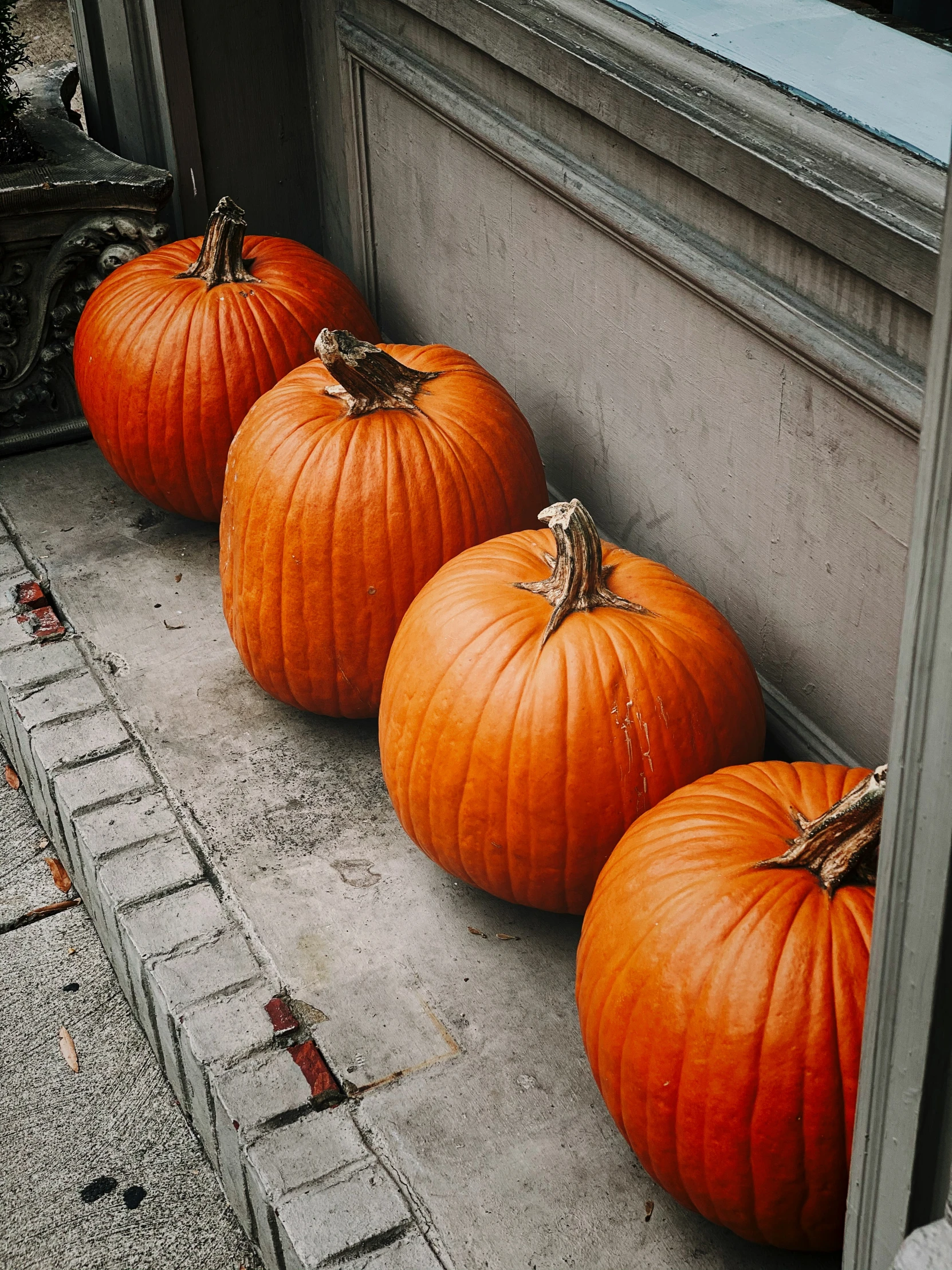 pumpkins that are sitting in front of a door