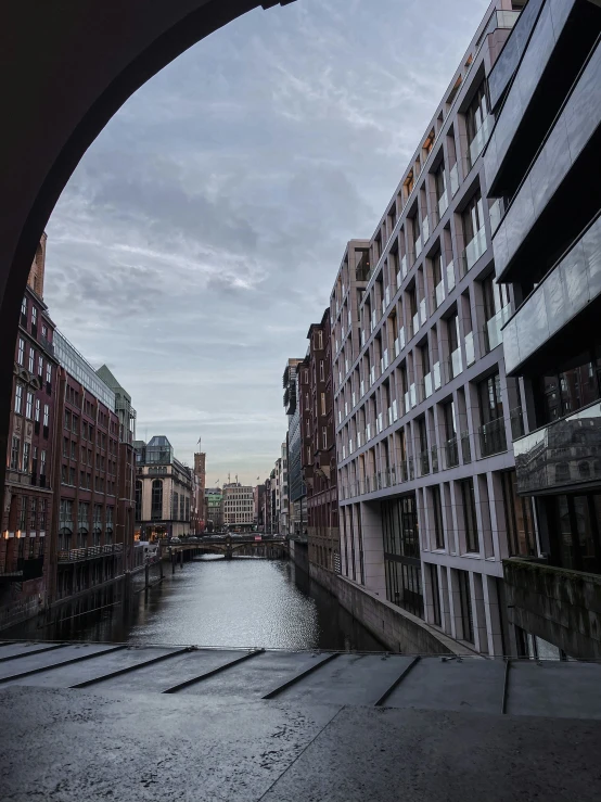 the street is next to the canal, and a building is up against it