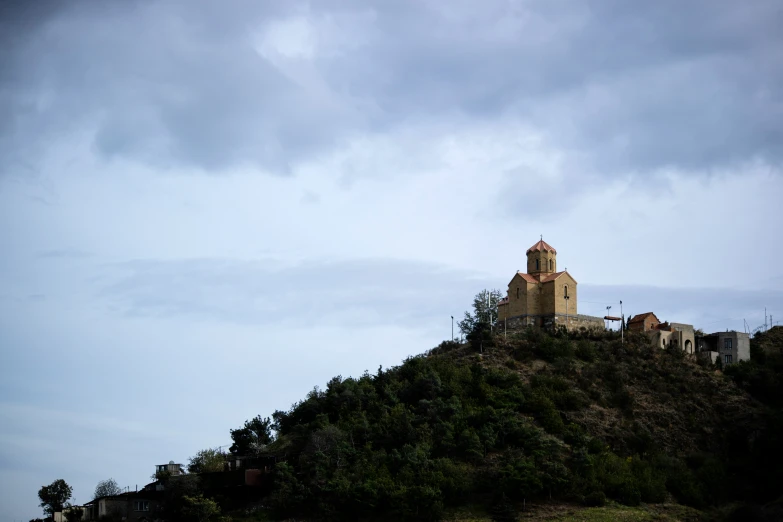 a church sits on top of a hill