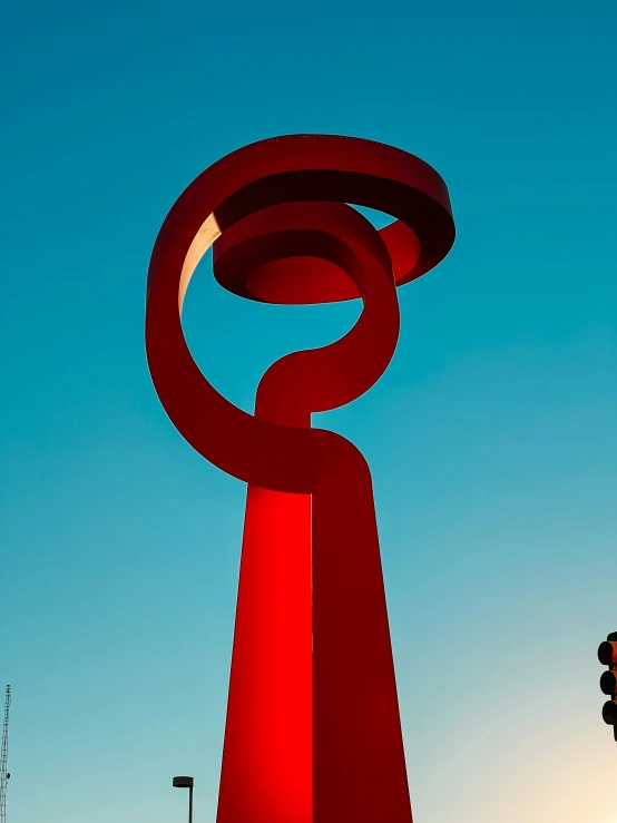 a very tall sculpture in the middle of a sunny sky