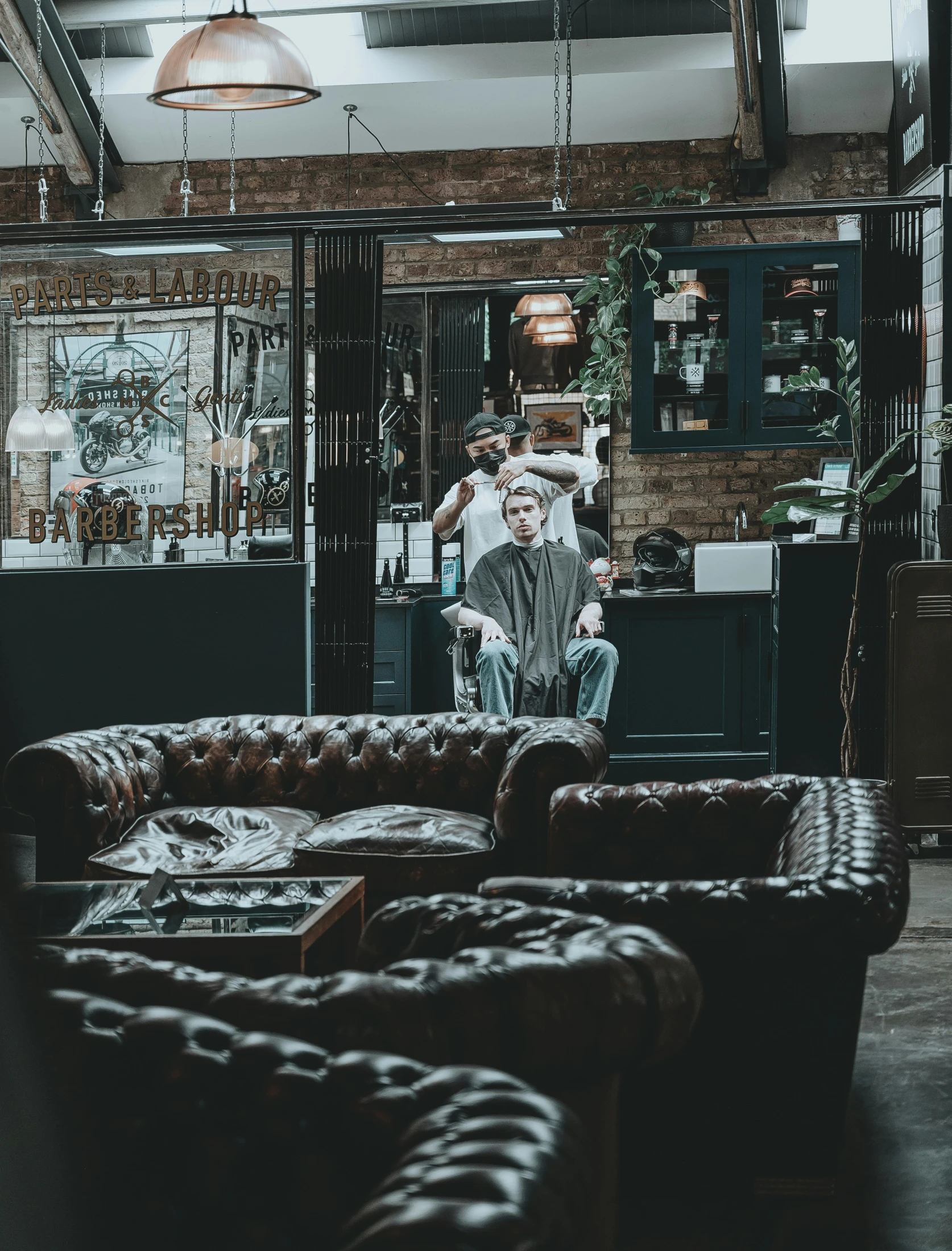 the man is sitting on his sofa in the bar