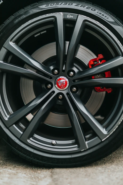 a close - up s of a car wheel with the red ke pads