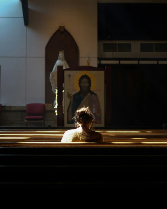 the light shining through a church window illuminates the image of a jesus on the screen