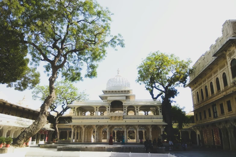 an outdoor view of a building with columns and domes