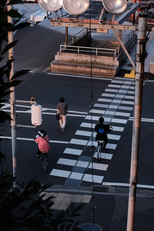 some people riding bikes down a road with many lights on top