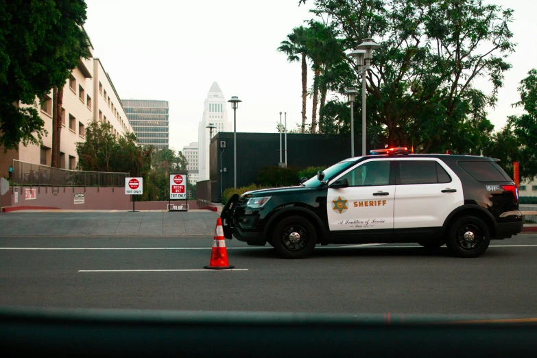 a police car and suv in an empty parking lot