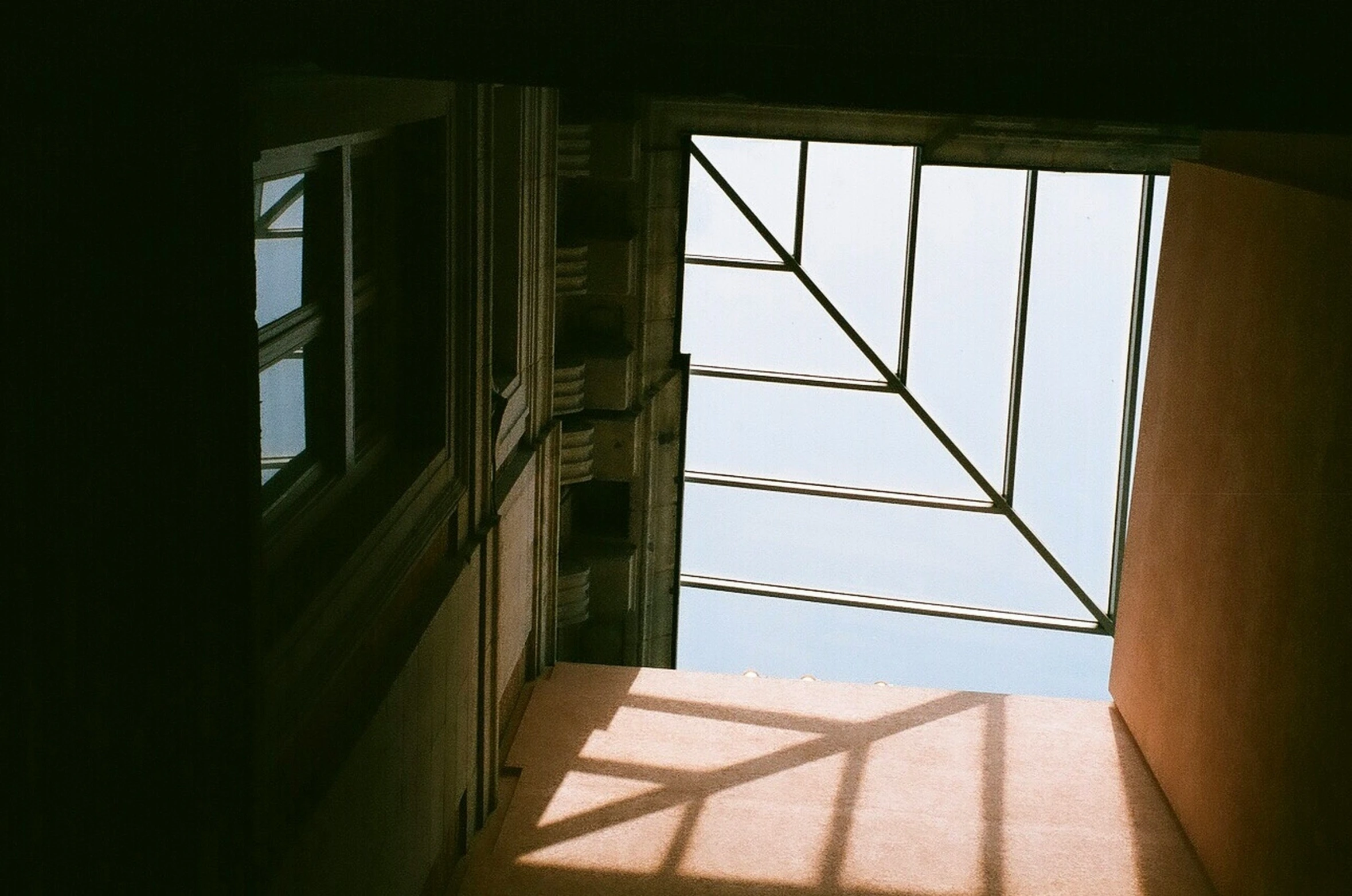 a narrow staircase in front of an open window