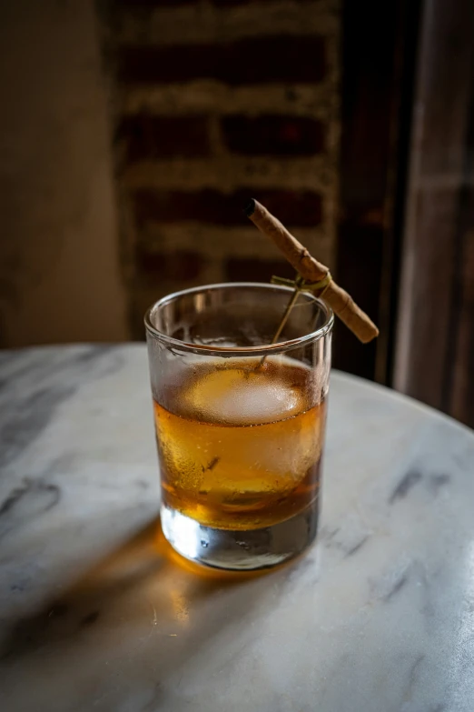 glass with liquor and an orange peel on the table