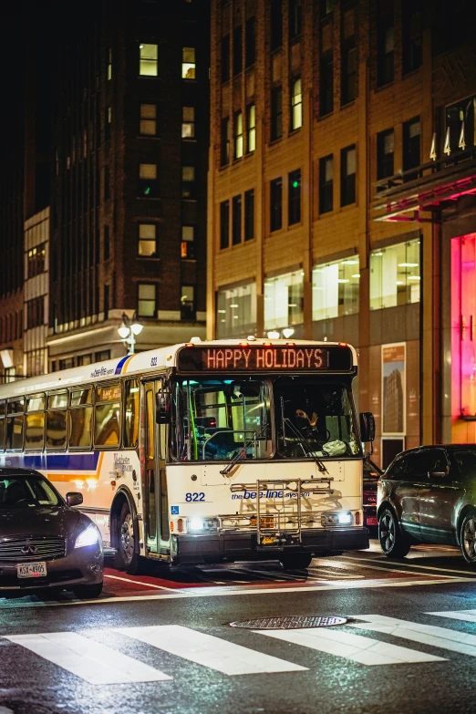 a bus turning on a street at night