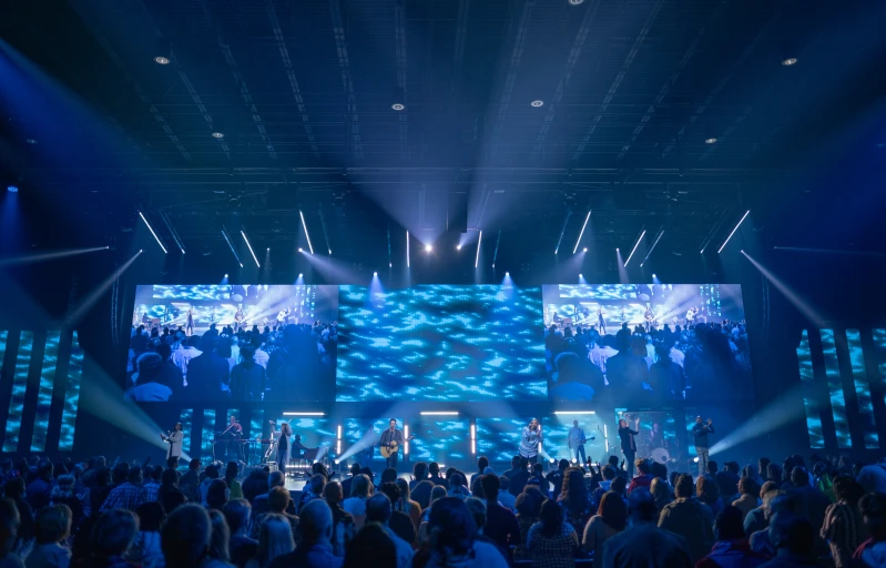 large event hall with large screen and bright lights