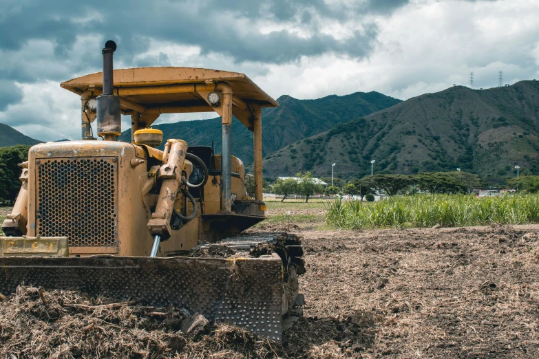 an old tractor being used as a farm equipment