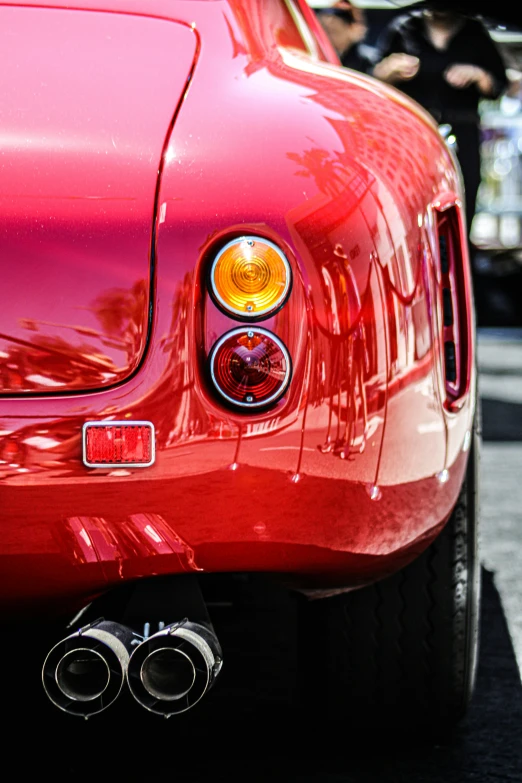 a close up of the noselights of a red sports car