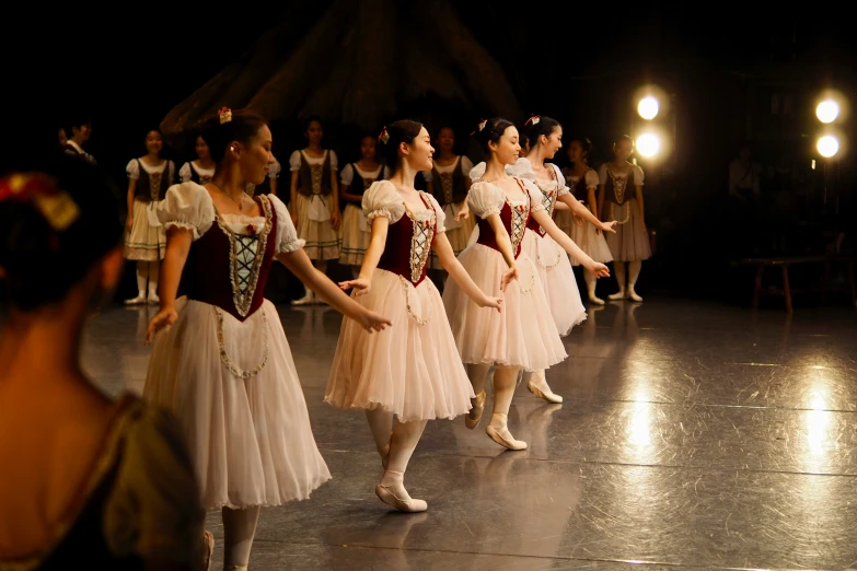 the young ballerinas are performing on stage