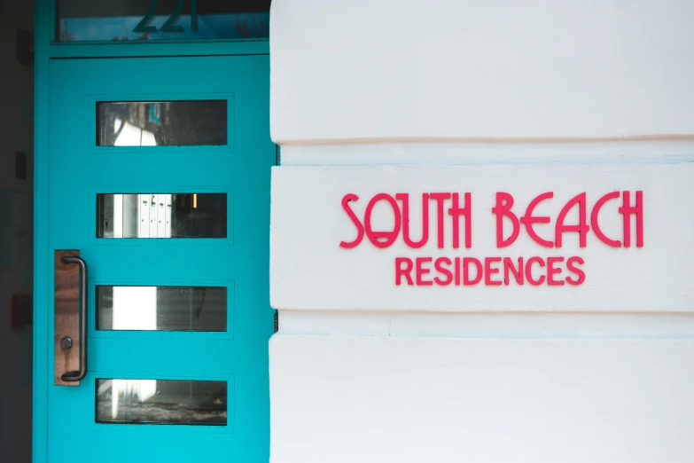 a blue door has the words south beach residences painted on it