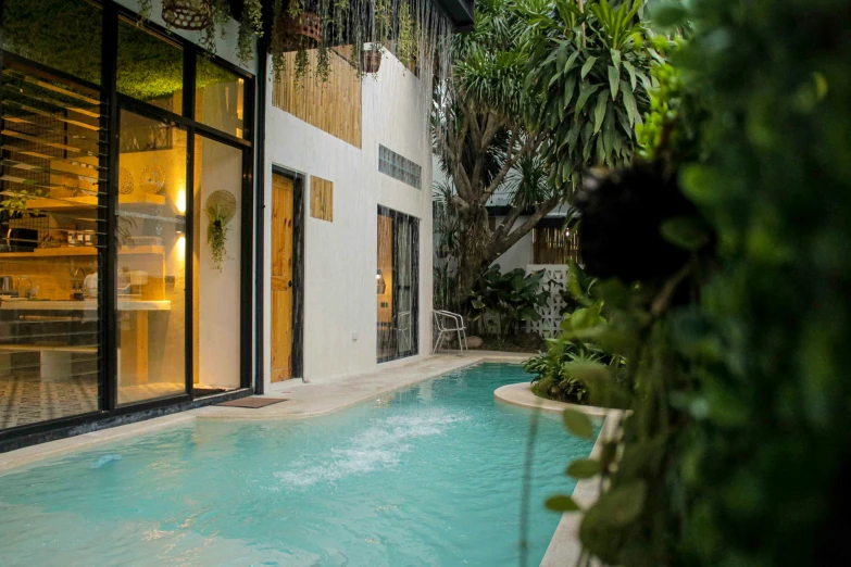 a pool outside of a building in front of trees