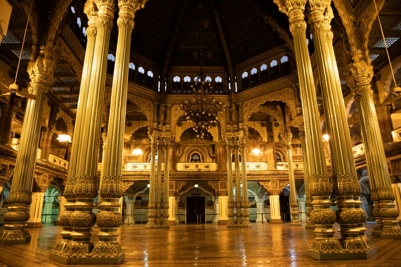 a huge hall with pillars and lights in a building