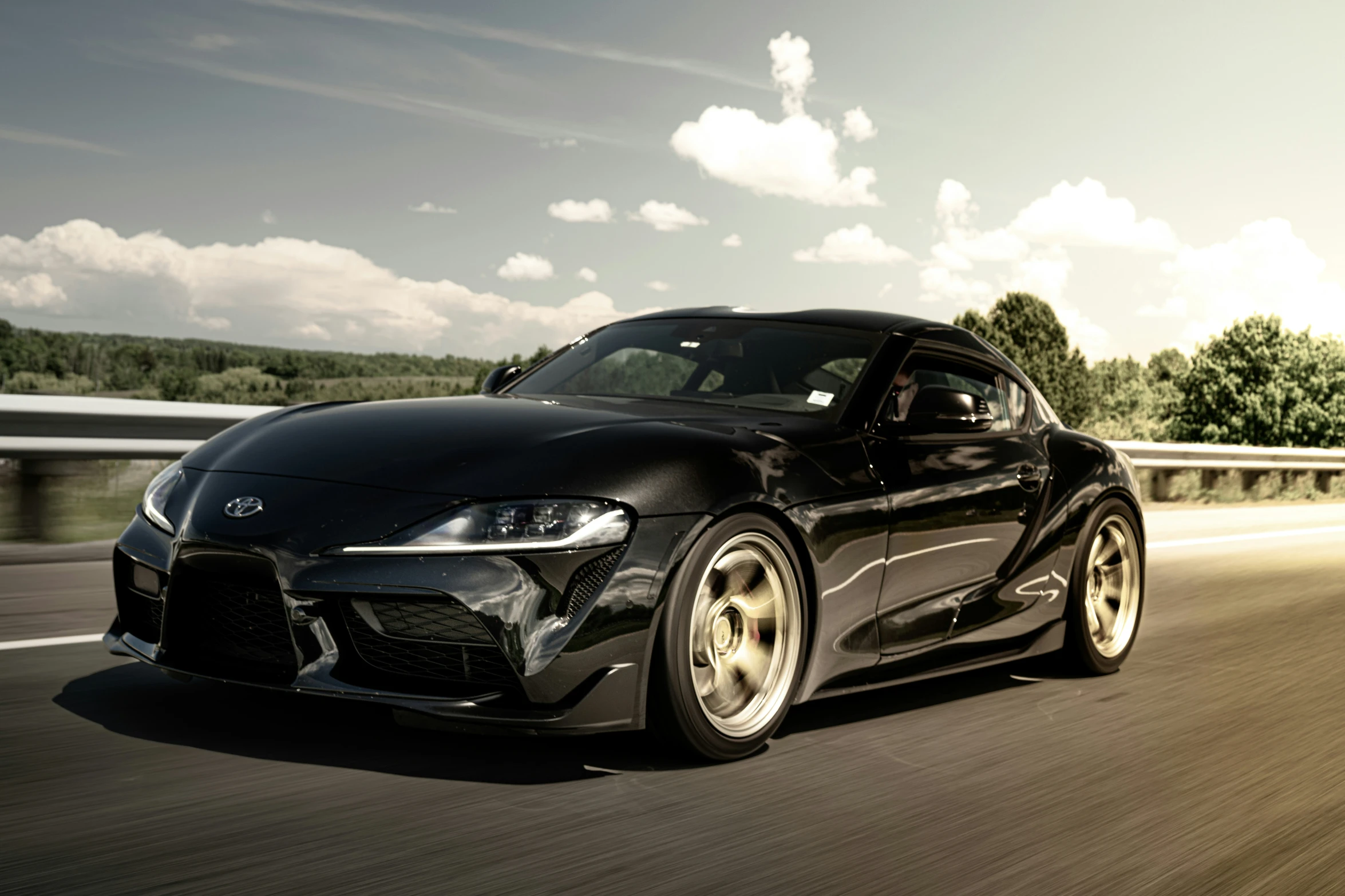 a sports car is driving on a road