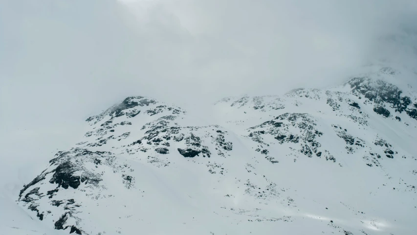 a snow covered mountain ridge with two skiers