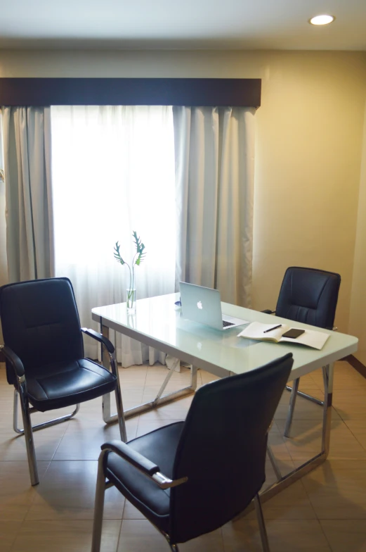 a dining room with a table, chair and laptop