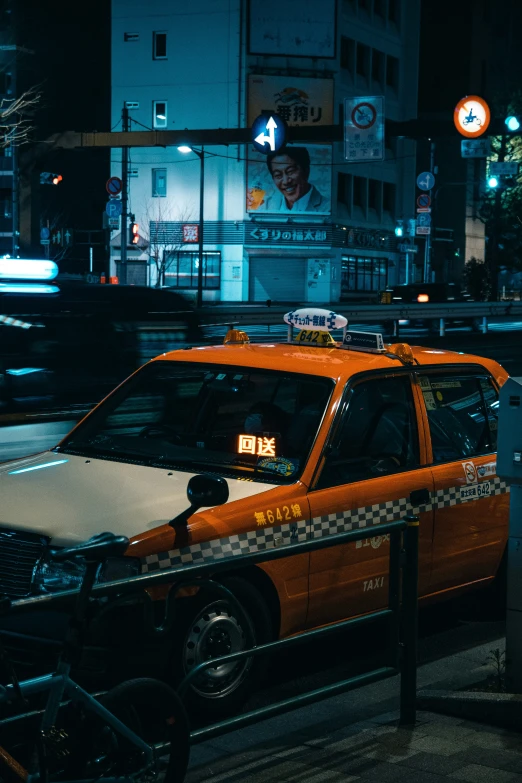 an orange taxi parked on the side of the street