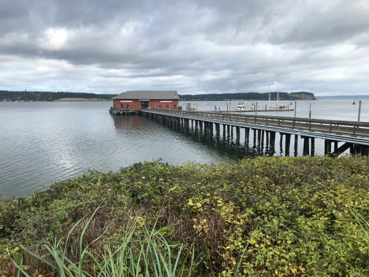 a large long pier with some boats in the water