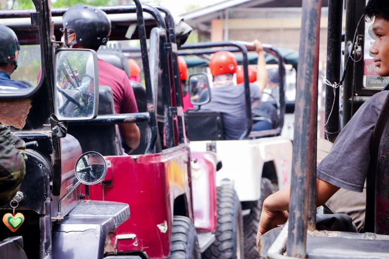 a man in a helmet riding on top of a jeep