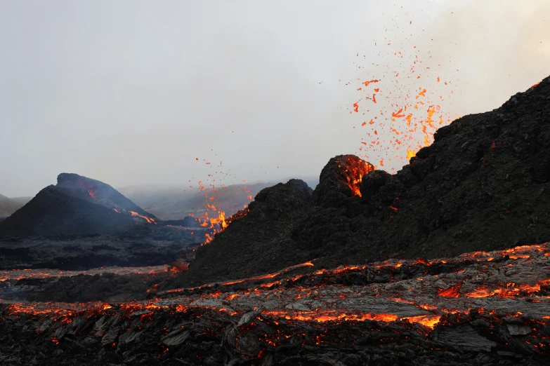 a big hill with some rocks and some red lava