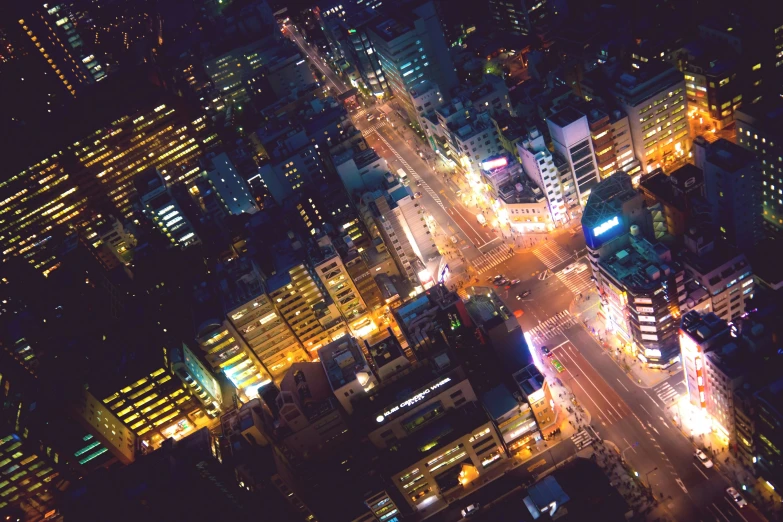 an aerial view of a city intersection at night