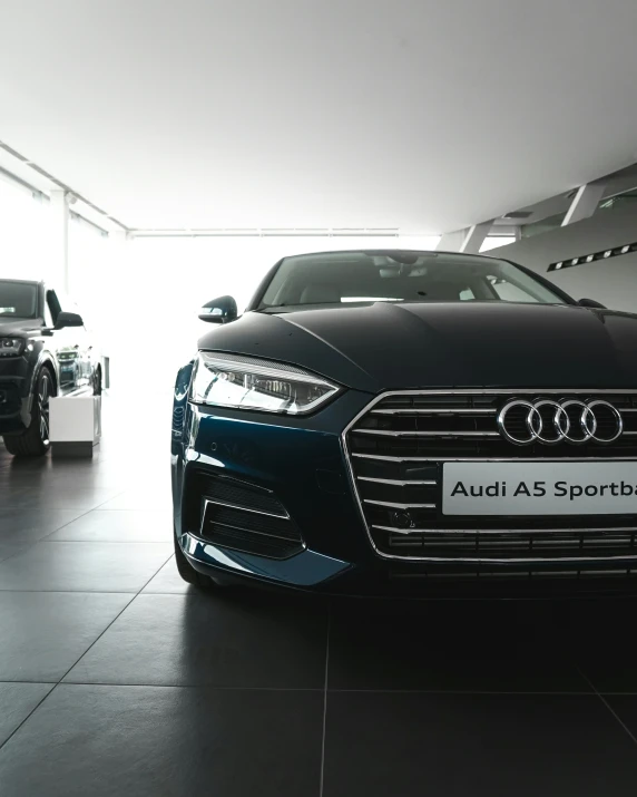 two vehicles that are on display in a garage