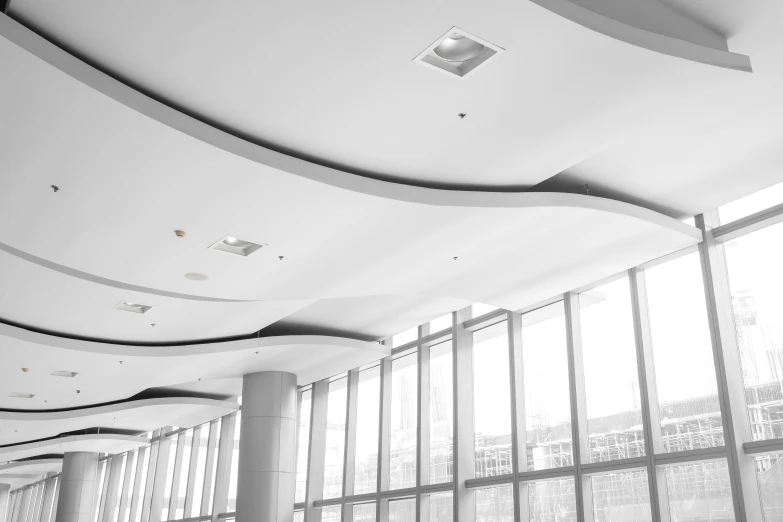 a white and black po of a long room with lots of windows