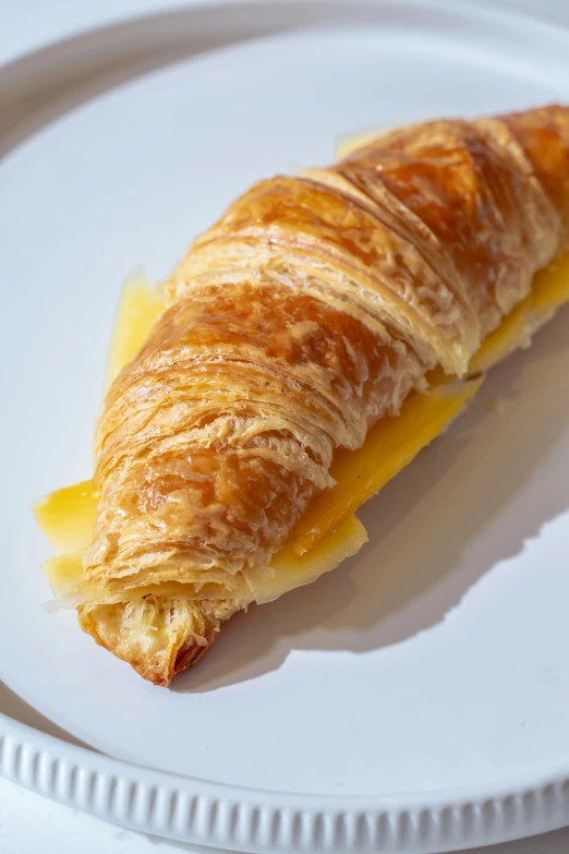 a pastry with orange filling on top of a white plate