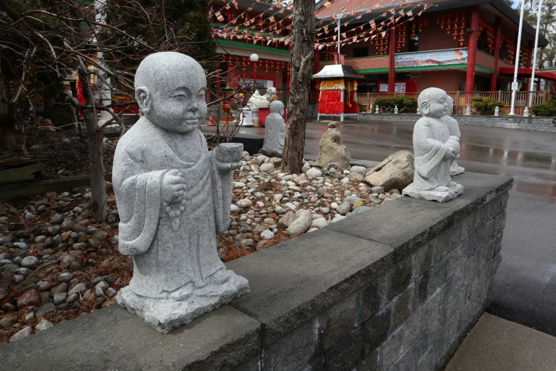 two statues are next to each other in a garden