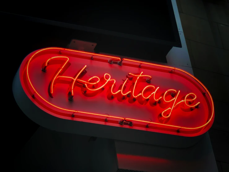 a neon sign that is attached to the side of a building