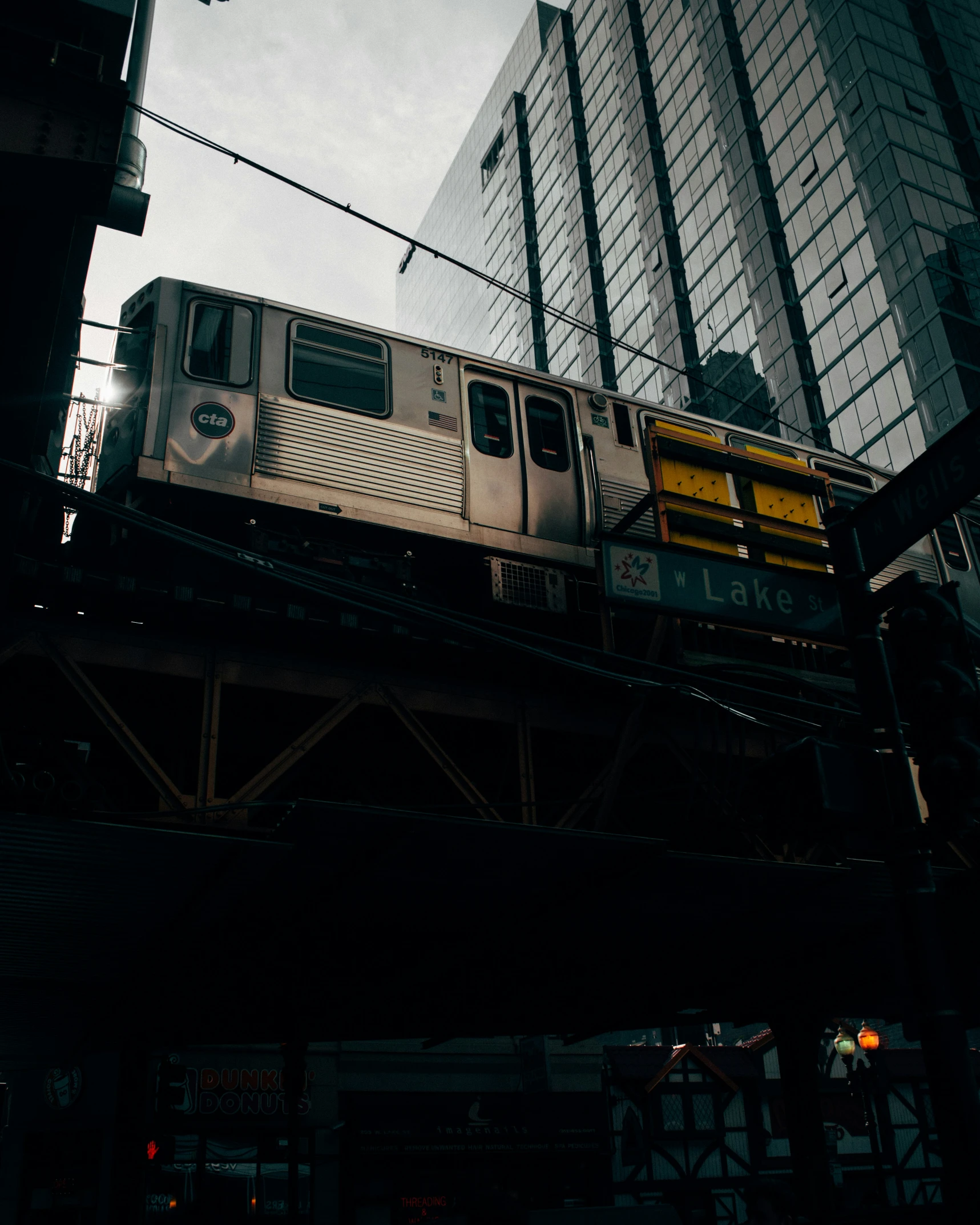 an electric train passing by a building near water