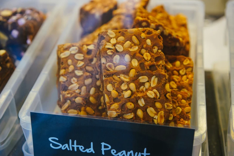 baked treats in plastic containers and labeled salted peanut bars