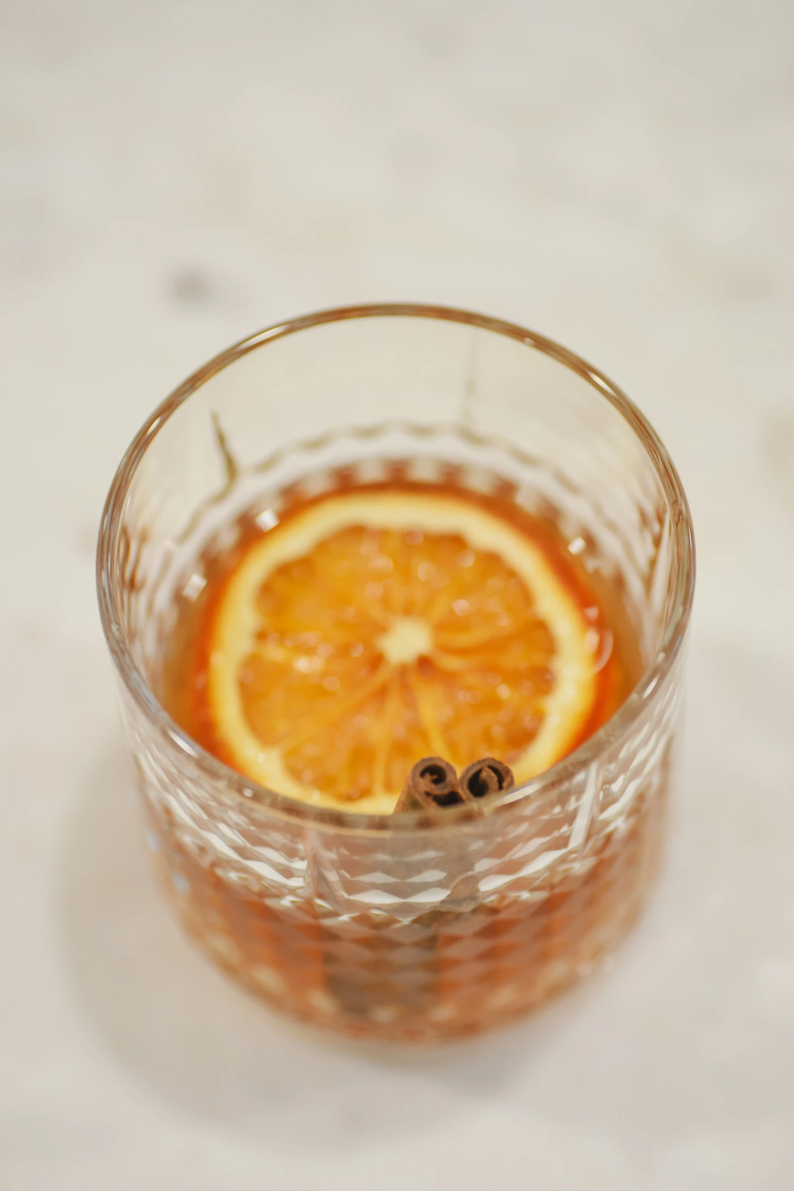 an orange cut into pieces inside of a glass