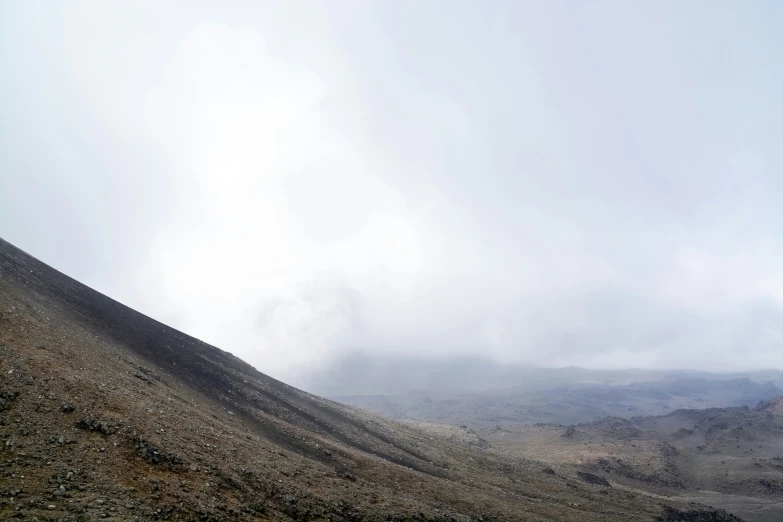 the view from behind of a hill in clouds