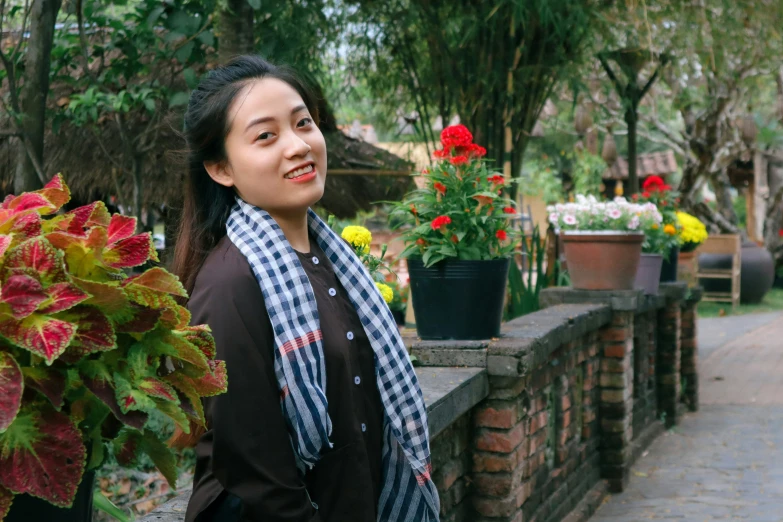 woman in scarf with flowers outside of residential home