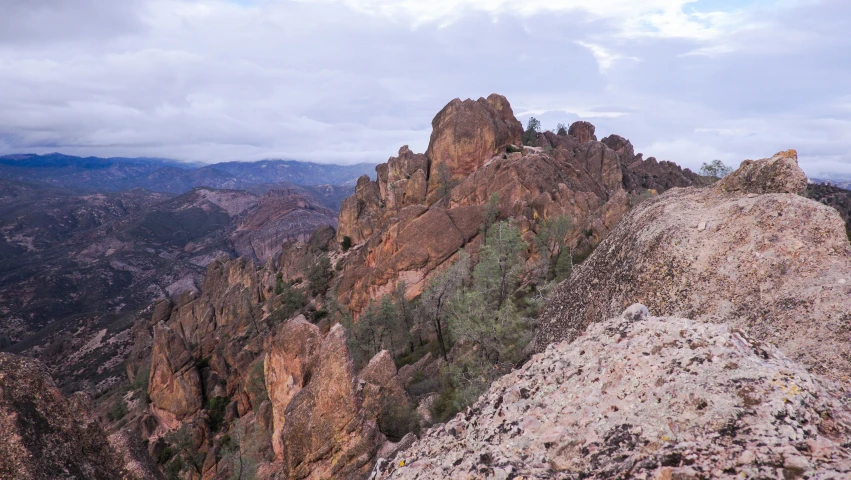 a man standing on top of a very tall hill